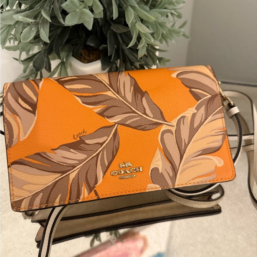 Coach Anna Foldover Crossbody Clutch with Banana Leaves print.